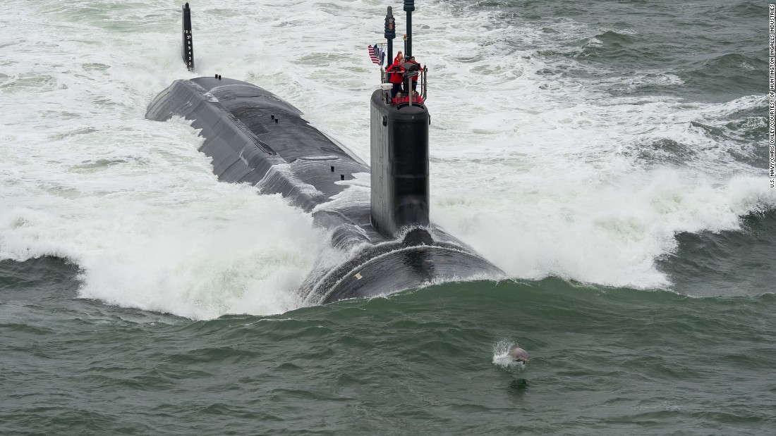 Dolphins love subs. USS John Warner Cmdr. Dan Caldwell said that when subs are cruising along the surface, dolphins are swimming along with them 90% of the time. Here a dolphin swims in front of the USS John Warner during its sea trials in May. Submariners actually wear medals on their uniforms that have dolphins on them.