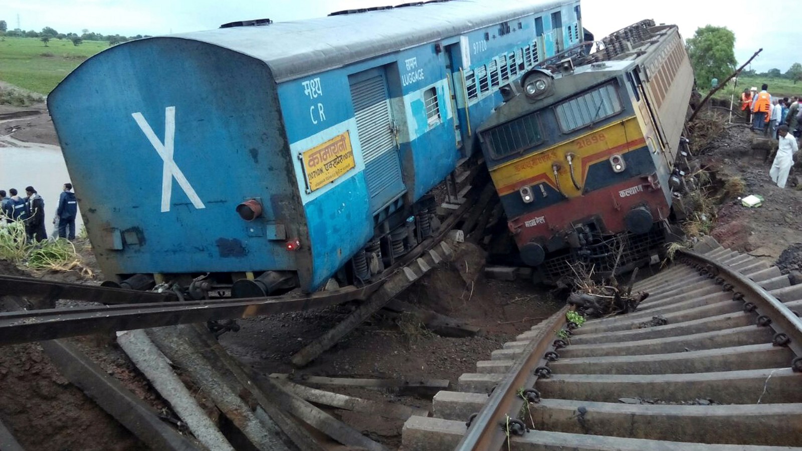 Twin trains veer off bridge in India killing dozens CNN
