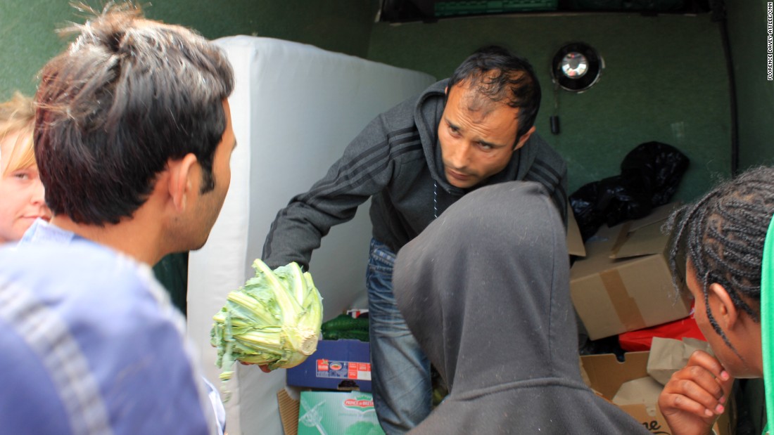 A local charity hands out food. People cover up their faces when the cameras are around because they don&#39;t want their families at home to see them in these conditions. Many people tell their families they are doing well in Europe.