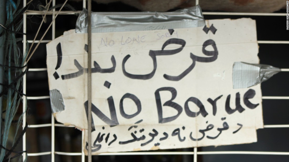 A sign reads &quot;no credit&quot; in three languages. Shopkeepers don&#39;t give loans to customers who they know might be on a truck across the English Channel the next day.