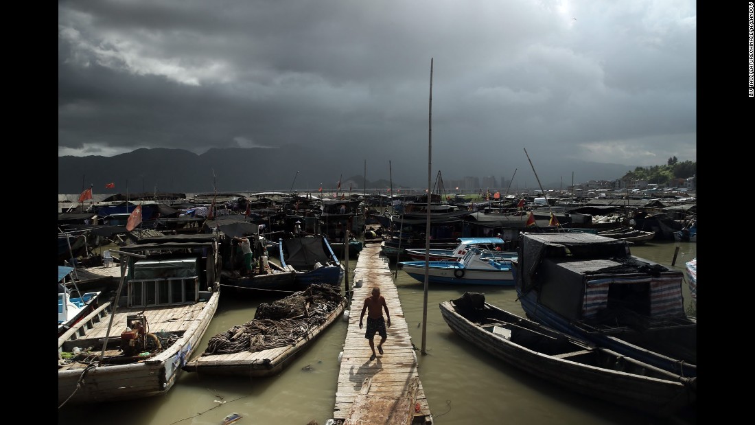 A fisherman walks on a pier in Ningde, China, on Friday, August 7. 