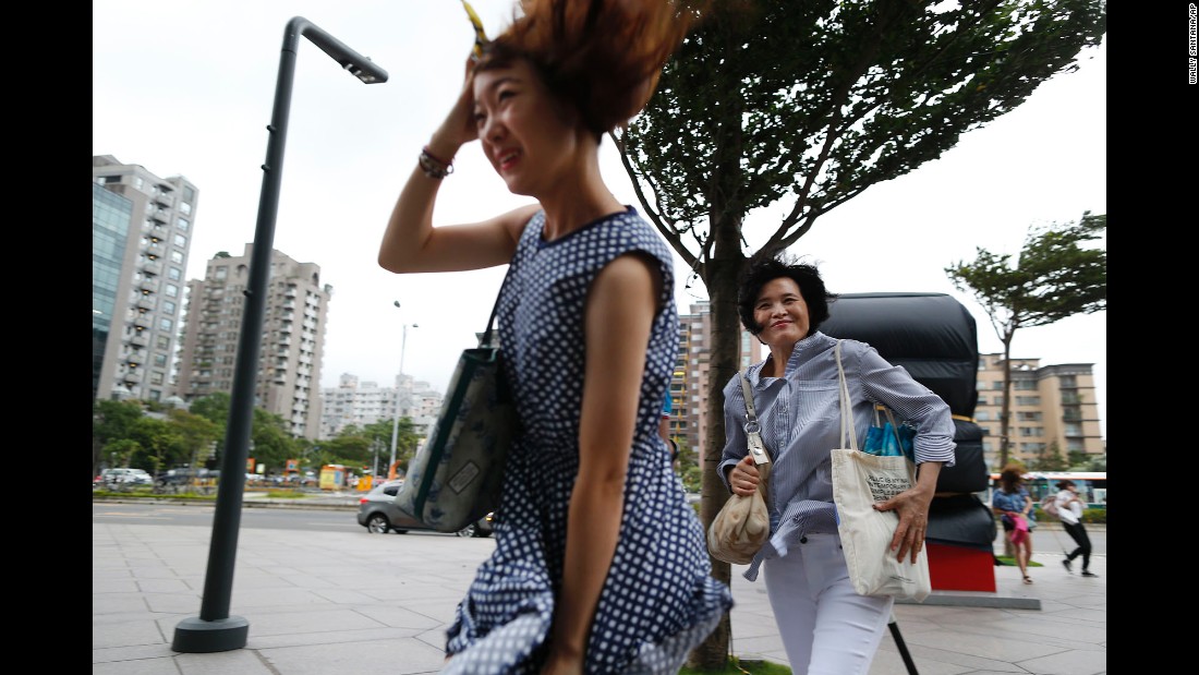 Two women battle the winds from the approaching typhoon in Taipei, Taiwan, on August 7.