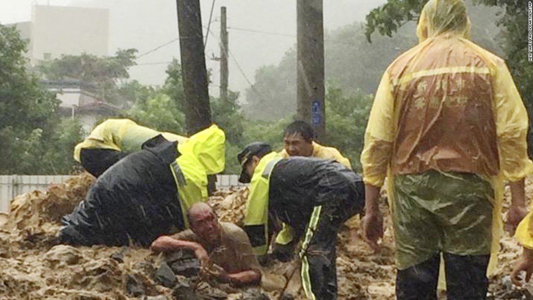 Emergency rescue personnel dig a man from a mudslide caused by Typhoon Soudelor in Xindian, New Taipei City, Taiwan, on Saturday, August 8. 