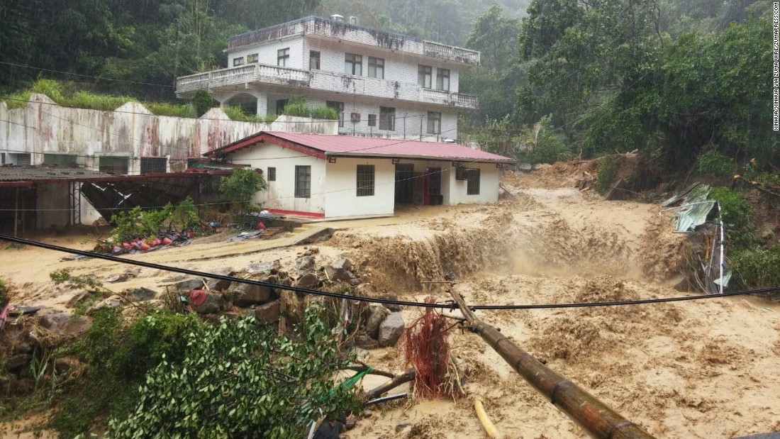 Water and mud flow around residential buildings in Xinbei City, Taiwan, on Saturday, August 8. 