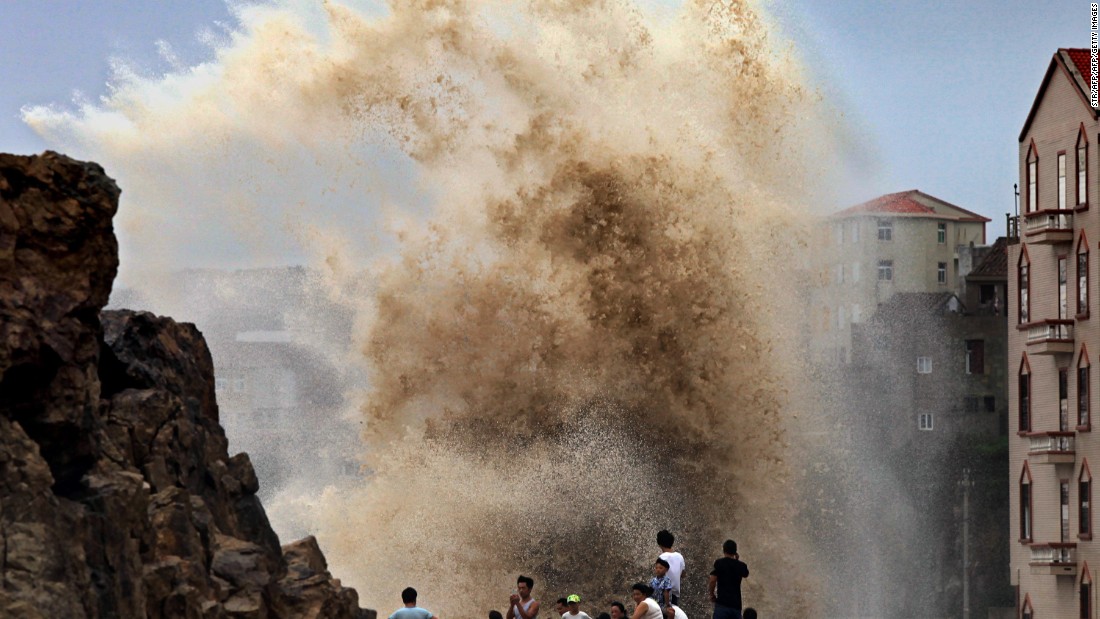 Residents gather to see huge waves stirred up by Typhoon Soudelor in Wenling, China, as the storm draws near the mainland on August 8. 