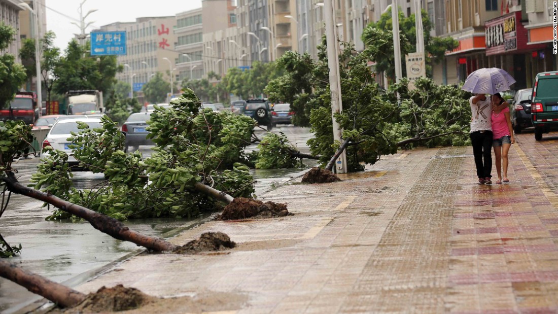 Trees torn down by strong wind are seen on the road in Jinjiang, China, on August 8. 