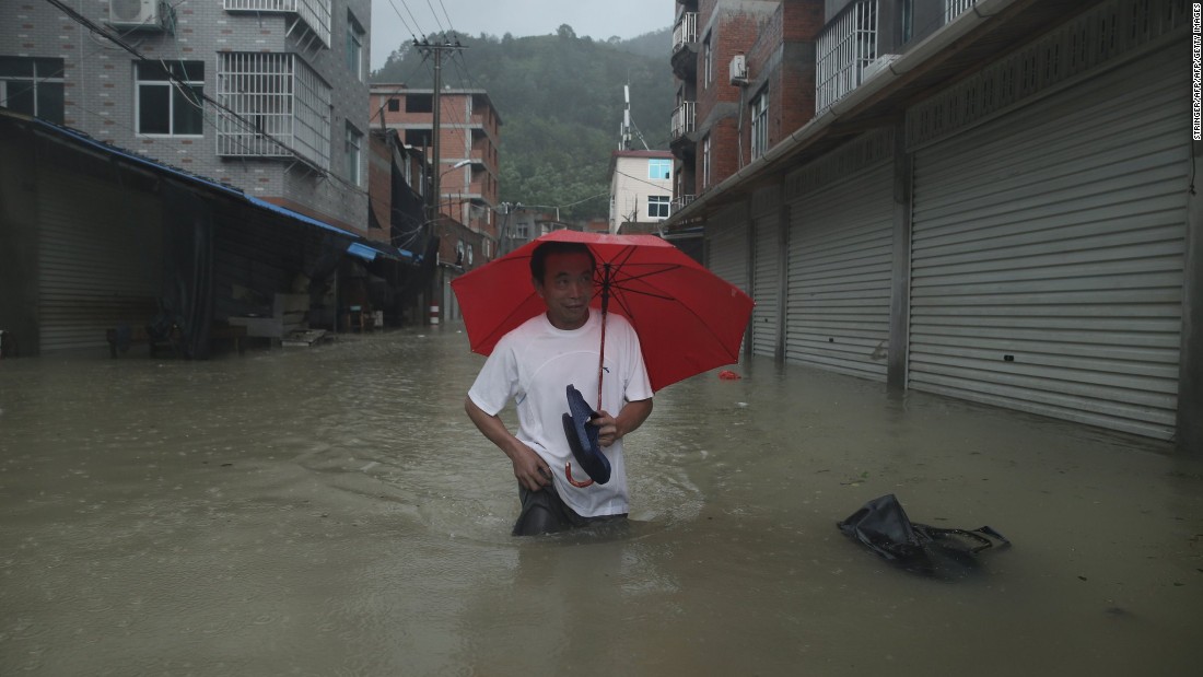A man wades through a flooded street in Ningde, China, on Sunday, August 9. Soudelor made landfall Saturday night in the city of Putian, in China&#39;s southern Fujian province. More than 185,000 people moved to higher ground, Xinhua reported. The typhoon weakened as it moved inland toward the northwest.