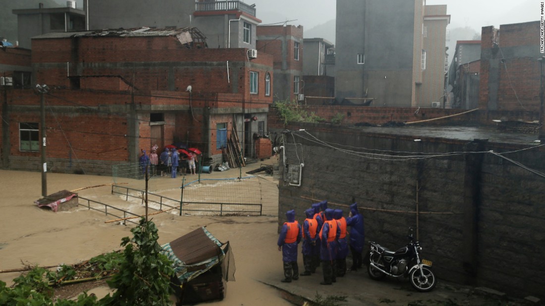 Rescuers stand by a flooded area in Ningde, China, on August 9. 