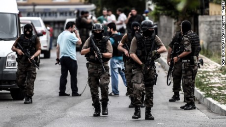 Turkish special force police officers take cover during clashes with attackers on August 10, 2015 at the Sultanbeyli district in Istanbul. Turkey&#39;s largest city Istanbul was Monday shaken by twin attacks on the US consulate and a police station as tensions spiral amid the government&#39;s air campaign against Kurdish militants.