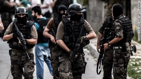 Turkish special force police officers take cover during clashes with attackers on August 10, 2015 at the Sultanbeyli district in Istanbul. Turkey&#39;s largest city Istanbul was Monday shaken by twin attacks on the US consulate and a police station as tensions spiral amid the government&#39;s air campaign against Kurdish militants. AFP PHOTO / OZAN KOSE        (Photo credit should read OZAN KOSE/AFP/Getty Images)