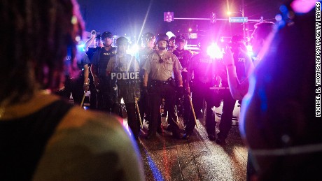 Police face off with protesters in Ferguson on August 9.