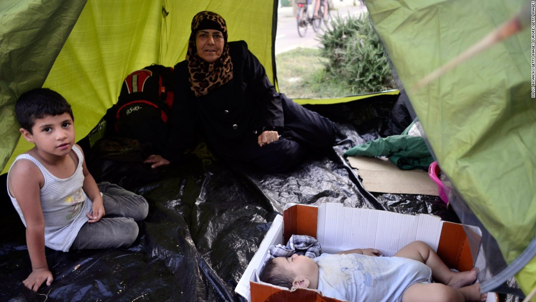 Syrian migrants take shelter at a makeshift camp in the center of town on August 12, in Kos.