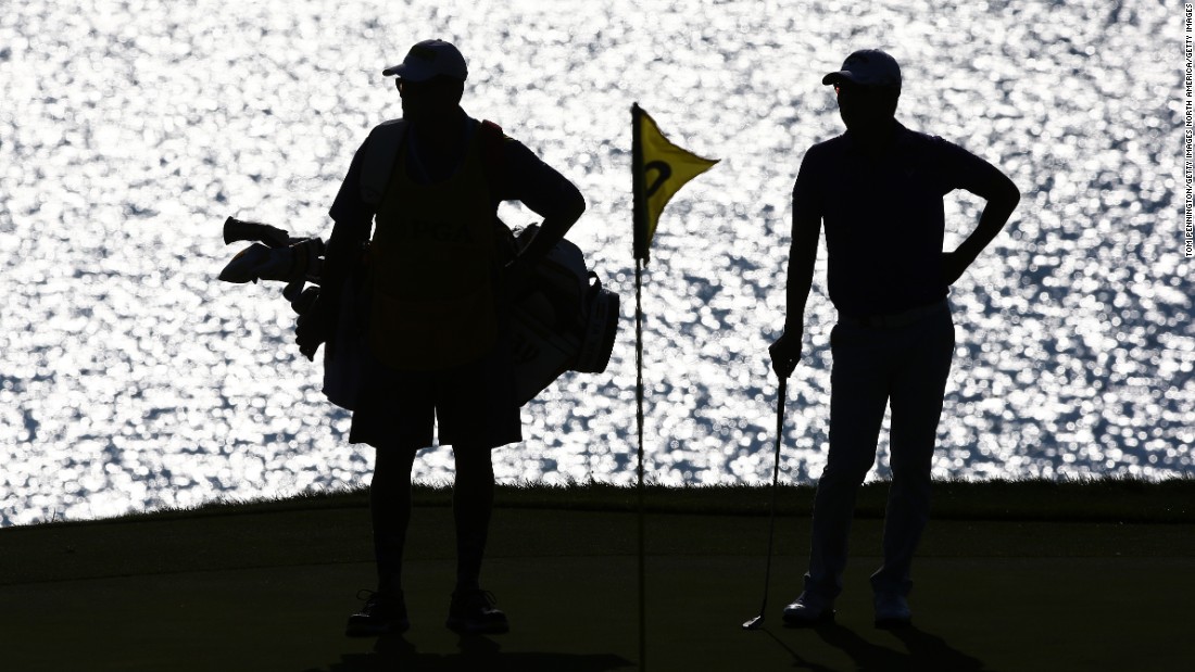 Bae Sang-Moon of South Korea waits with his caddy on the second green on Friday.