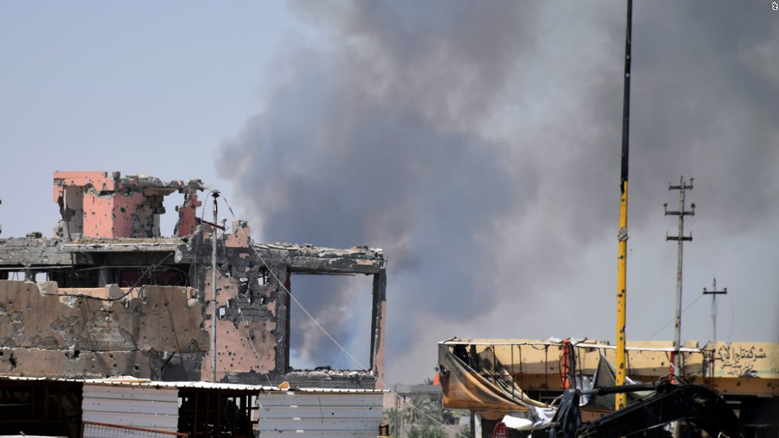 Smoke rises above a damaged building in Ramadi, Iraq, following a coalition airstrike against ISIS positions on Saturday, August 15.