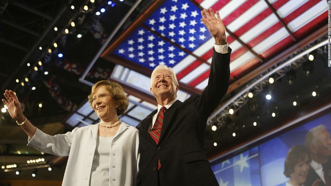 The Carters wave to the audience during the Democratic National Convention in July 2004.