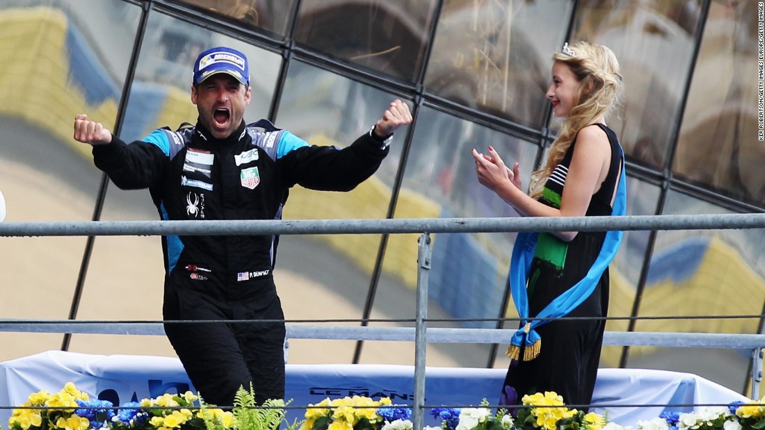 Dempsey celebrates on the podium after finishing second in the GTE Am class during the Le Mans 24 Hour race.