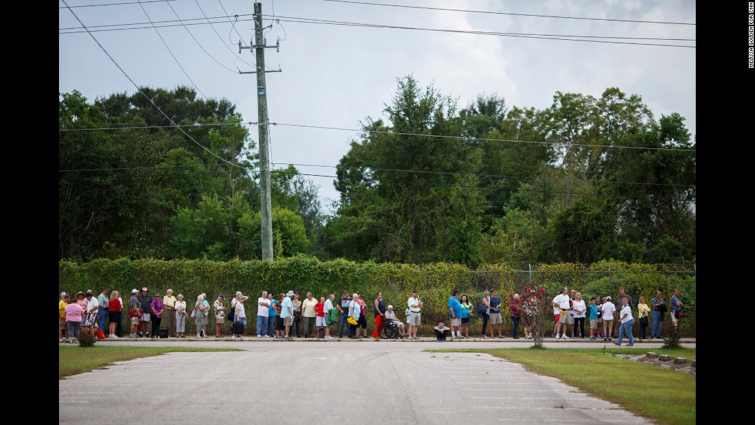 People queue in line to wait for the doors to open. The event was previously planned to be held at the nearby Civic Center but was moved to the 43,000-seat Ladd-Peebles Stadium, a venue normally home to high school football games, to accommodate the crowd. The city of Mobile confirmed late Friday that 30,000 people attended.