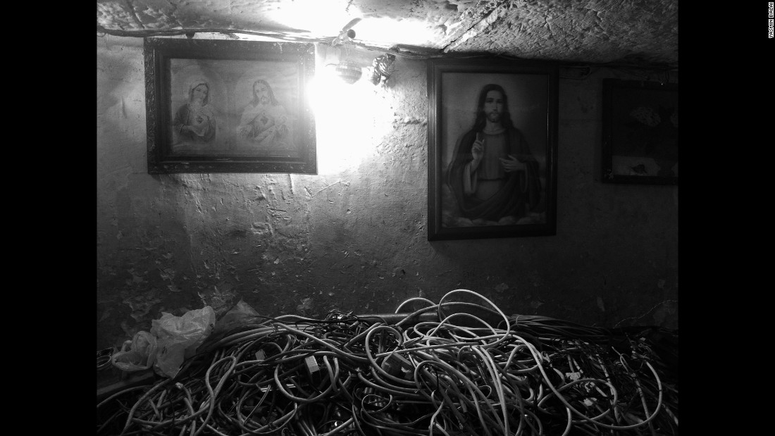 Religious paintings hang on walls inside the tunnels.