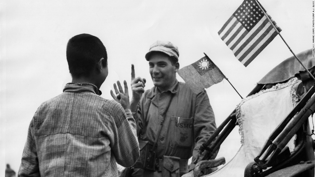 Marine Corporal Richard W. Miller bargains with a Chinese man for a lift in his rickshaw on September 30, 1945. This image was among 23,000 discovered by Chinese historian Zhang Dongpan in 2006 in the U.S. National Archives and Records Office. 