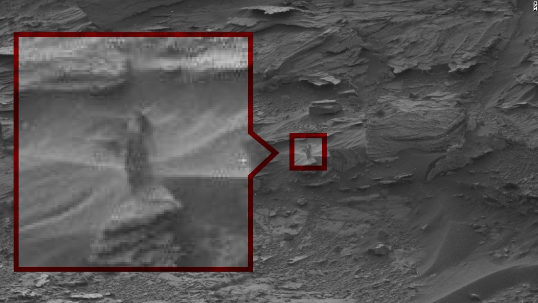 The Strange Lady: This ghost-like &quot;woman&quot; seems to peering down at Curiosity from a cliff. NASA says it&#39;s probably just an oddly shaped drift of sand.
