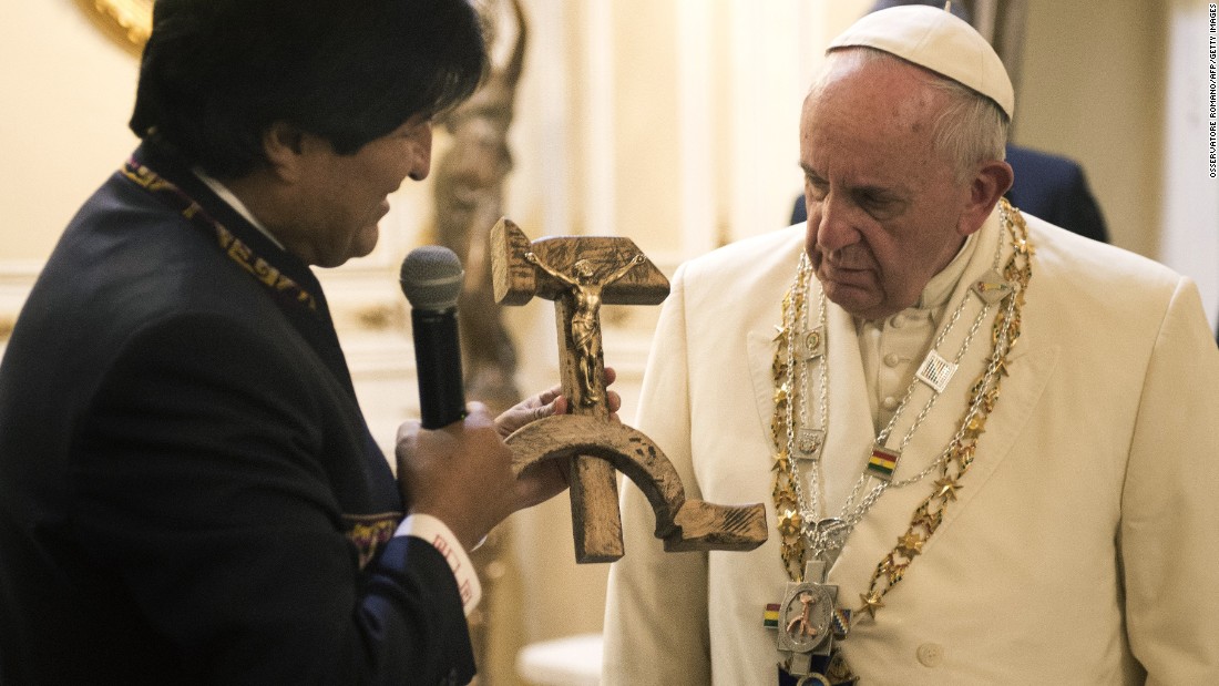 Bolivian President Evo Morales presents the Pope with a gift of a crucifix carved into a wooden hammer and sickle -- the Communist symbol uniting laborers and peasants -- in La Paz, Bolivia, on Wednesday, July 8, 2015.