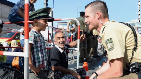 Flood of migrants arrive in Germany after grueling trek