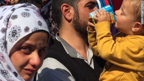 A woman filled with emotion cries at the Munich train station after fleeing Syria.