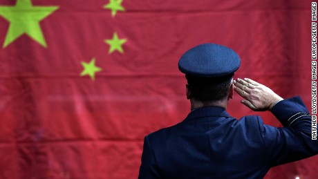 LONDON, ENGLAND - SEPTEMBER 08:  A military honour guard raises the flag of China during a table tennis medal ceremony on day 10 of the London 2012 Paralympic Games at ExCel on September 8, 2012 in London, England.  (Photo by Matthew Lloyd/Getty Images)