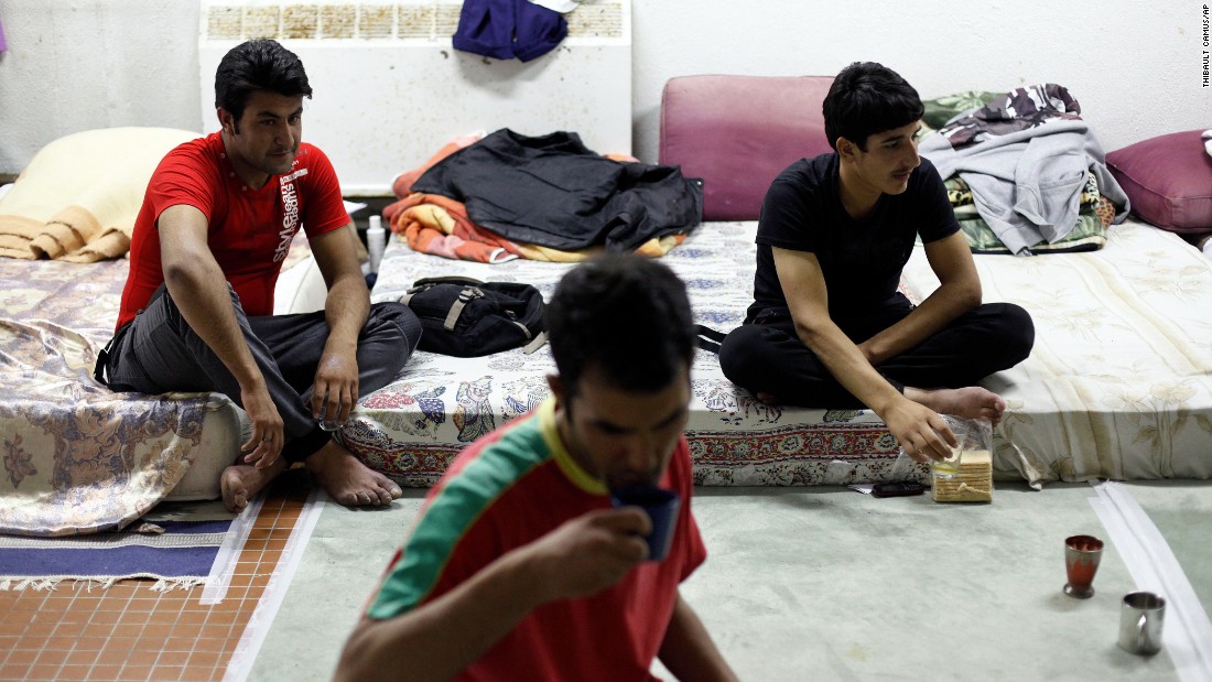 Migrants from Afghanistan drink tea at a Paris school where they found shelter.