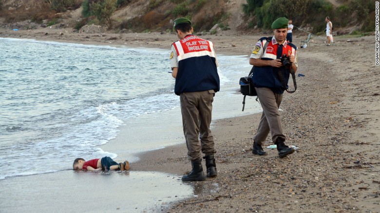 Authorities stand near the body of 2-year-old Alan Kurdi on the shore of Bodrum, Turkey, in September 2015. Alan, his brother and their mother &lt;a href=&quot;http://www.cnn.com/2015/09/03/europe/migration-crisis-aylan-kurdi-turkey-canada/index.html&quot; target=&quot;_blank&quot;&gt;drowned while fleeing Syria.&lt;/a&gt; This photo was shared around the world, often with a Turkish hashtag that means &quot;Flotsam of Humanity.&quot;