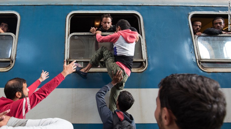 Migrants board a train at Keleti station in Budapest, Hungary, after the station was reopened in September 2015.