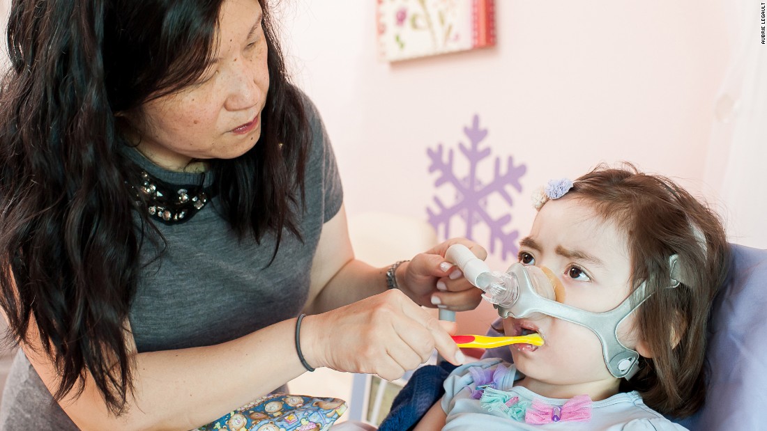 Julianna, who has Charcot-Marie-Tooth disease, once had nearly full use of her arms, but now can&#39;t even hold a small toy without help. Her mother, Michelle Moon, brushes her teeth. 