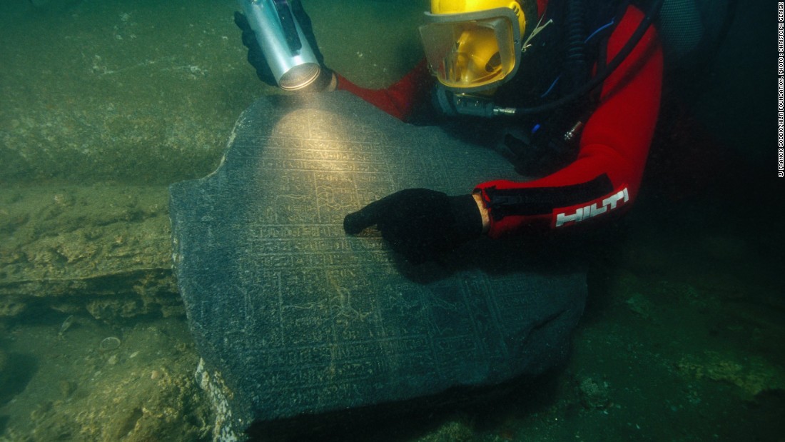 A diver inspects portions of a cella, a rectangular room found inside Greek temples, one of about 250 ancient Egyptian artifacts once thought to be lost to history, now on display in Paris.
