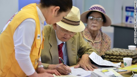 An elderly South Korean man (C) who left behind relatives in North Korea fills out applications for an expected inter-Korean family reunion programme at the Red Cross office in Seoul on September 7, 2015. North and South Korean Red Cross officials kicked off talks on September 7 on organising a rare and emotional reunion for families separated by the Korean War.  AFP PHOTO / JUNG YEON-JE        (Photo credit should read JUNG YEON-JE/AFP/Getty Images)