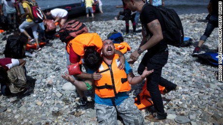 A refugee from Syria prays after arriving on the shores of the Greek island of Lesbos aboard an inflatable dinghy across the Aegean Sea from from Turkey on September 7, 2015. Greece sent troops and police reinforcements on September 6 to Lesbos after renewed clashes between police and migrants, the public broadcaster said, while Syrian refugees on the island were targeted with Molotov cocktail attacks. More than 230,000 people have landed on Greek shores this year and the numbers have soared in recent weeks as people seek to take advantage of the calm summer weather. AFP PHOTO / ANGELOS TZORTZINIS        (Photo credit should read ANGELOS TZORTZINIS/AFP/Getty Images)