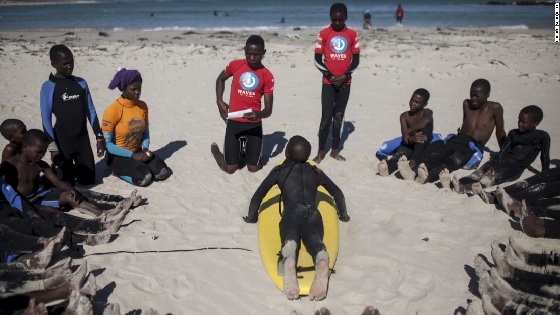 Kids at Monwabisi Beach in Khayelitsha learn the surfing basics from local coaches.