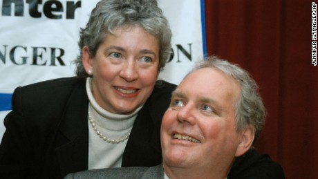 Lucinda Marker wraps her arm around her husband, John Tull, at Beth Israel Hospital in New York in February 2004.