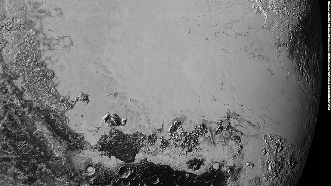 Scientists say that what looks like mountains could be huge blocks of frozen water suspended in frozen nitrogen. On the new photos, taken on July 14 and released on September 10, a pixel is 400 meters (440 yards). New Horizons&#39; closest pass by Pluto took it about 50,000 miles from the surface.