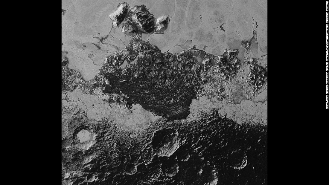 Pluto&#39;s landscape has lots of variety: plains, mountains, craters and what looks like they might be dunes. The smallest details on the photos are about half a mile wide. The area with the craters is ancient, scientist say. The smooth frozen planes are relatively young.