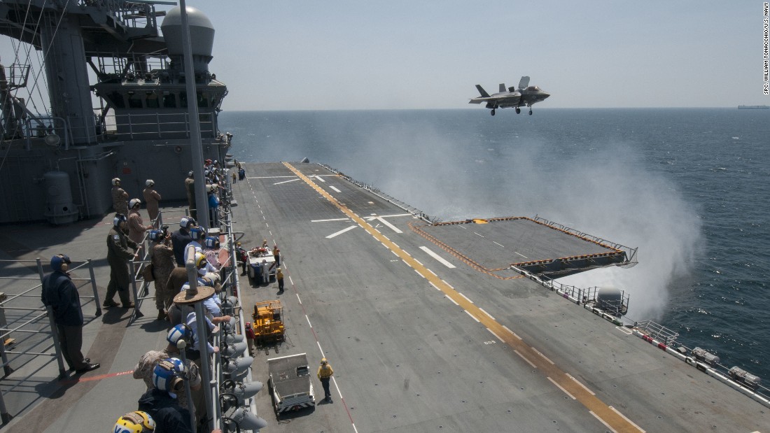 Sailors and distinguished visitors watch an F-35B Lightning II aircraft conduct vertical takeoff and landing flight operations aboard the amphibious assault ship USS Wasp in May 2015. Click through the gallery to see more images from the testing.