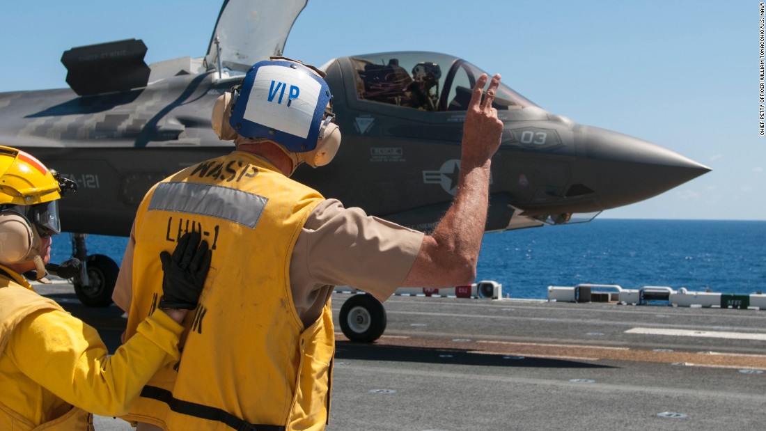 Vice Adm. William Hilrides, commander of Naval Sea Systems Command, holds up two fingers to indicate to the F-35B Lightning II pilot to power up for takeoff aboard the amphibious assault ship the amphibious assault ship USS Wasp in May.