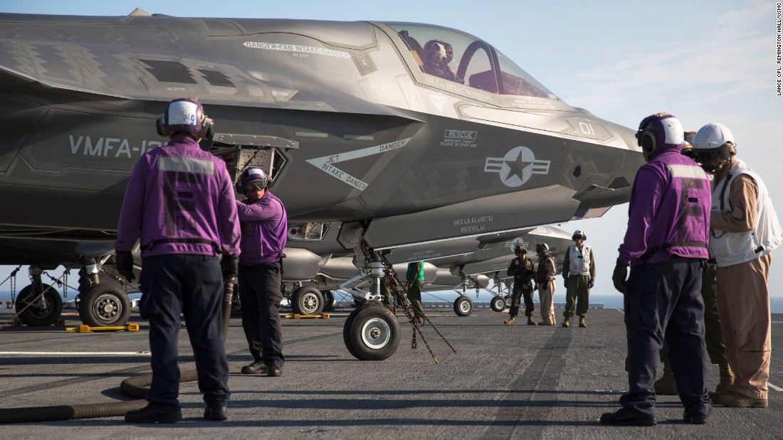 Marines and sailors aboard the amphibious assault ship USS Wasp secure and refuel an F-35B Lightning II fighter after its arrival for the first session of operational testing.