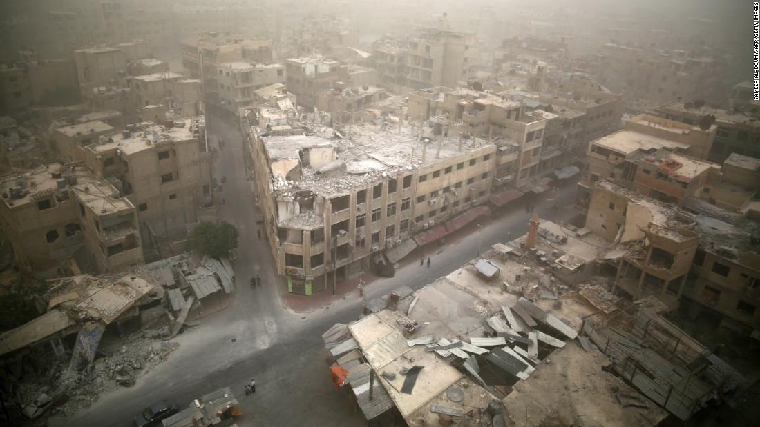 A sandstorm blows over damaged buildings in the rebel-held area of Douma, east of Damascus, on September 7, 2015.