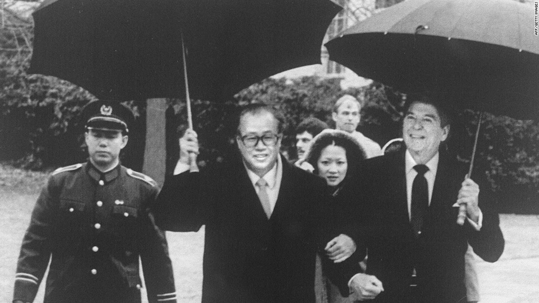 U.S. President Ronald Reagan and former Chinese Premier Zhao Ziyang walk arm in arm in the rain after a meeting at the White House in January, 1984. Zhao -- and Hu Yaobang, General Secretary of the Communist Party -- were the first Chinese leaders to wear a Western suit, during a period when China&#39;s reform and opening took off.