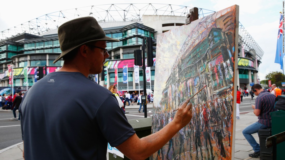 An artist paints outside Twickenham ahead of England&#39;s game against Fiji.
