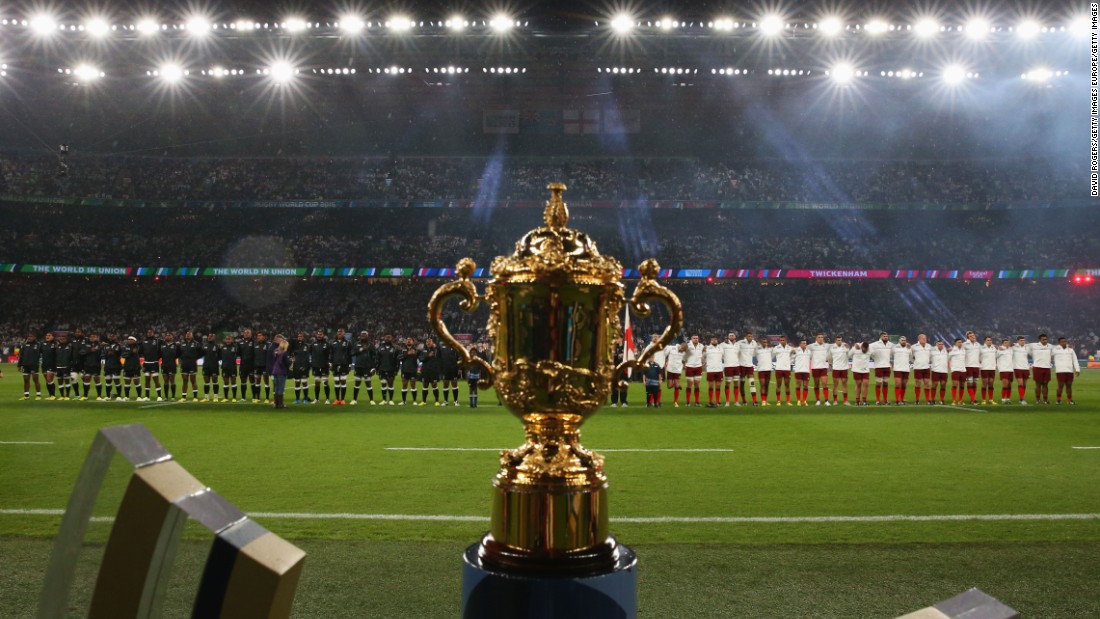 The two teams line up for the national anthems behind the Webb Ellis Cup, the prize for the world champions.