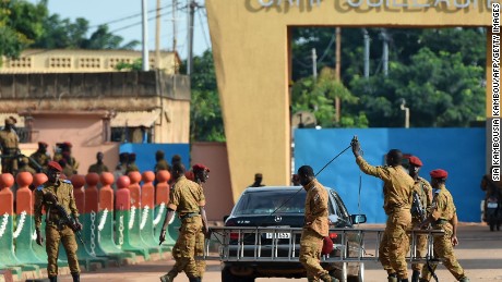 Burkina Faso army troops stand guard outside Guillaume Ouedraogo military camp in Ouagadougou on Tuesday, September 22, 2015.
