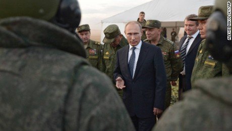 Russian President Vladimir Putin, center, meets with officers after military exercises at Donguz range in Orenburg region, about 1300 kilometers (800 miles) southeast of Moscow, Russia, Saturday, Sept. 19, 2015. Russian President Vladimir Putin on Saturday signaled his intentions to establish a Russian military air base in neighboring Belarus. (Alexei Nikolsky/RIA-Novosti, Kremlin Pool Photo via AP)