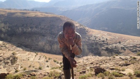 Rutland had lived in Asia and Europe but never seen much of his own continent. Pictured, a boy poses for Rutland&#39;s camera in one of Lesotho&#39;s mountains.