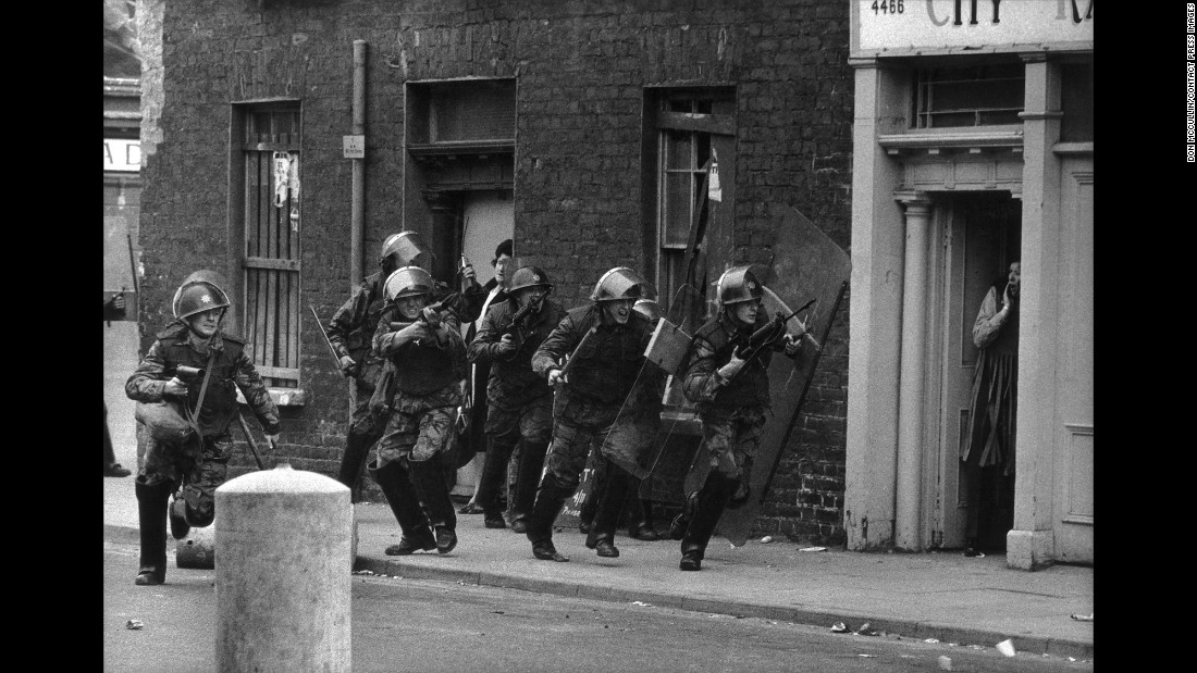 English soldiers charge Catholic youths in Londonderry, Northern Ireland, in 1970.